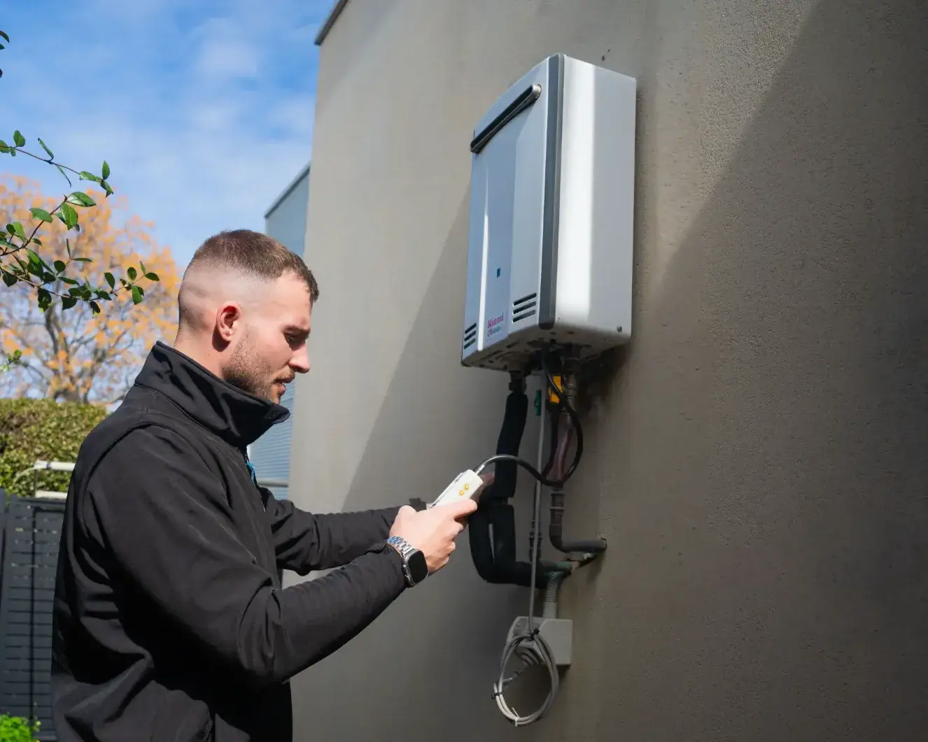 Loyal plumber conducting hot water unit installation in Adelaide
