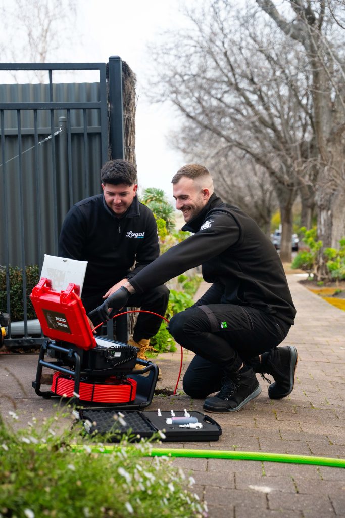 Plumber with CCTV drain camera: Loyal Plumbing plumber performing CCTV drain camera inspection for blocked drain in Craigmore SA
