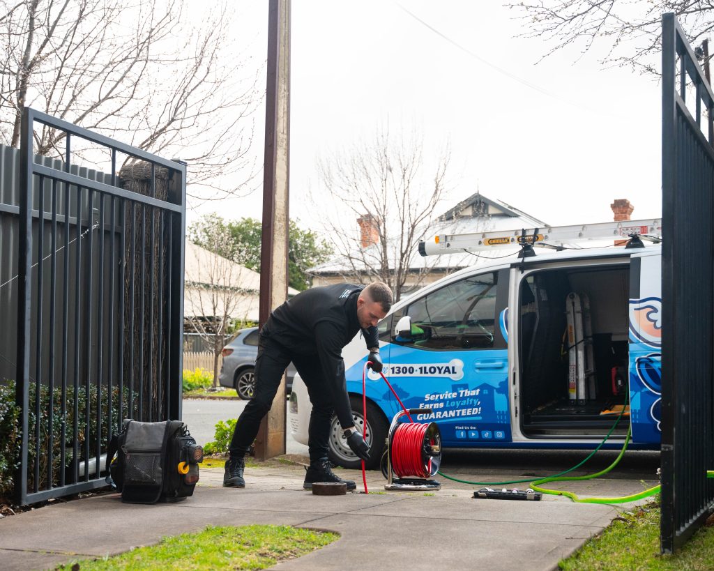 Plumber with hydro jet/high pressure water jetter: Loyal Plumbing licensed plumber clearing blocked drain with high pressure water jetter in Craigmore Adelaide